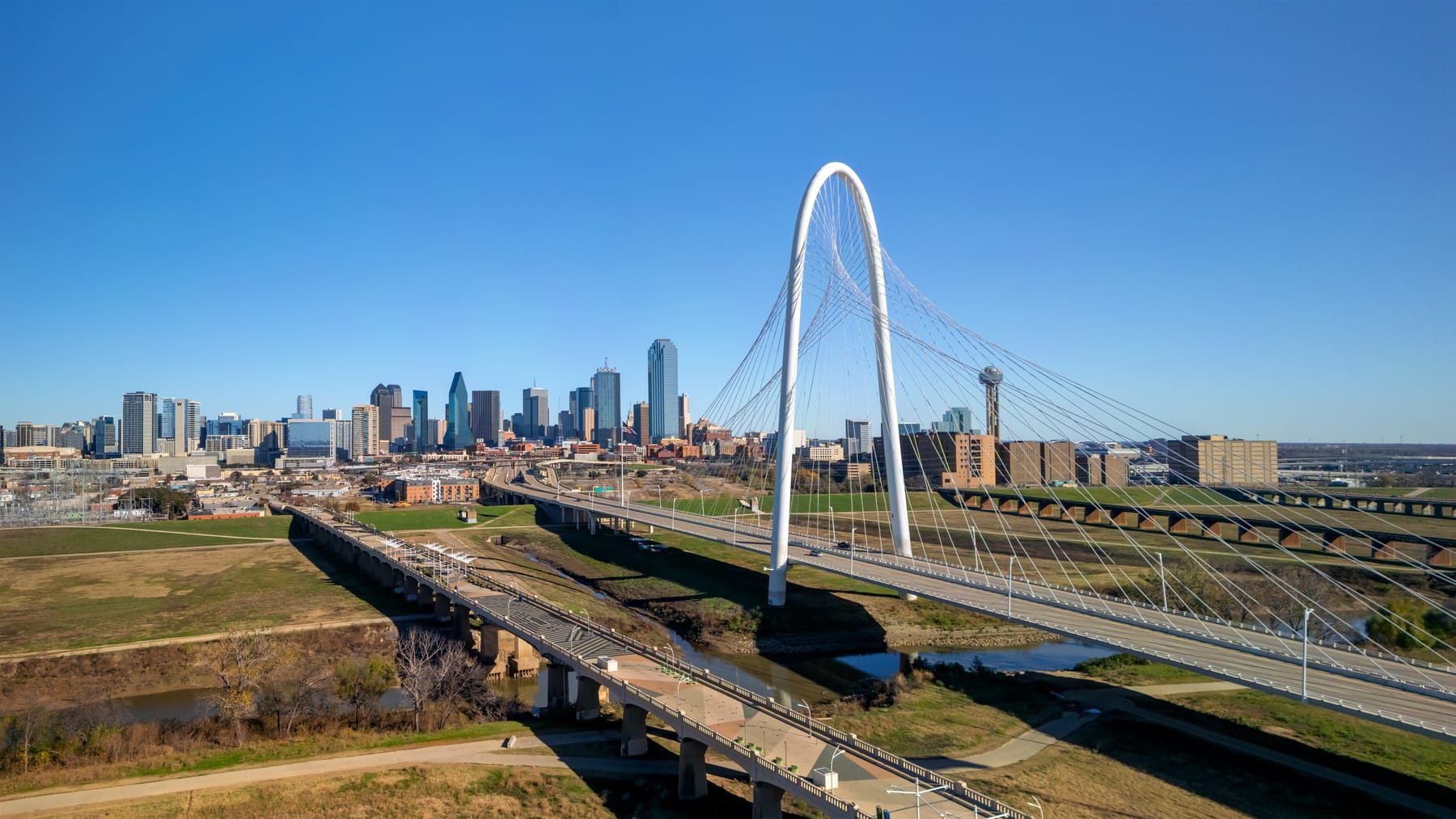 The Margaret Hunt Hill Bridge over the Trinity River, with the Dallas skyline behind