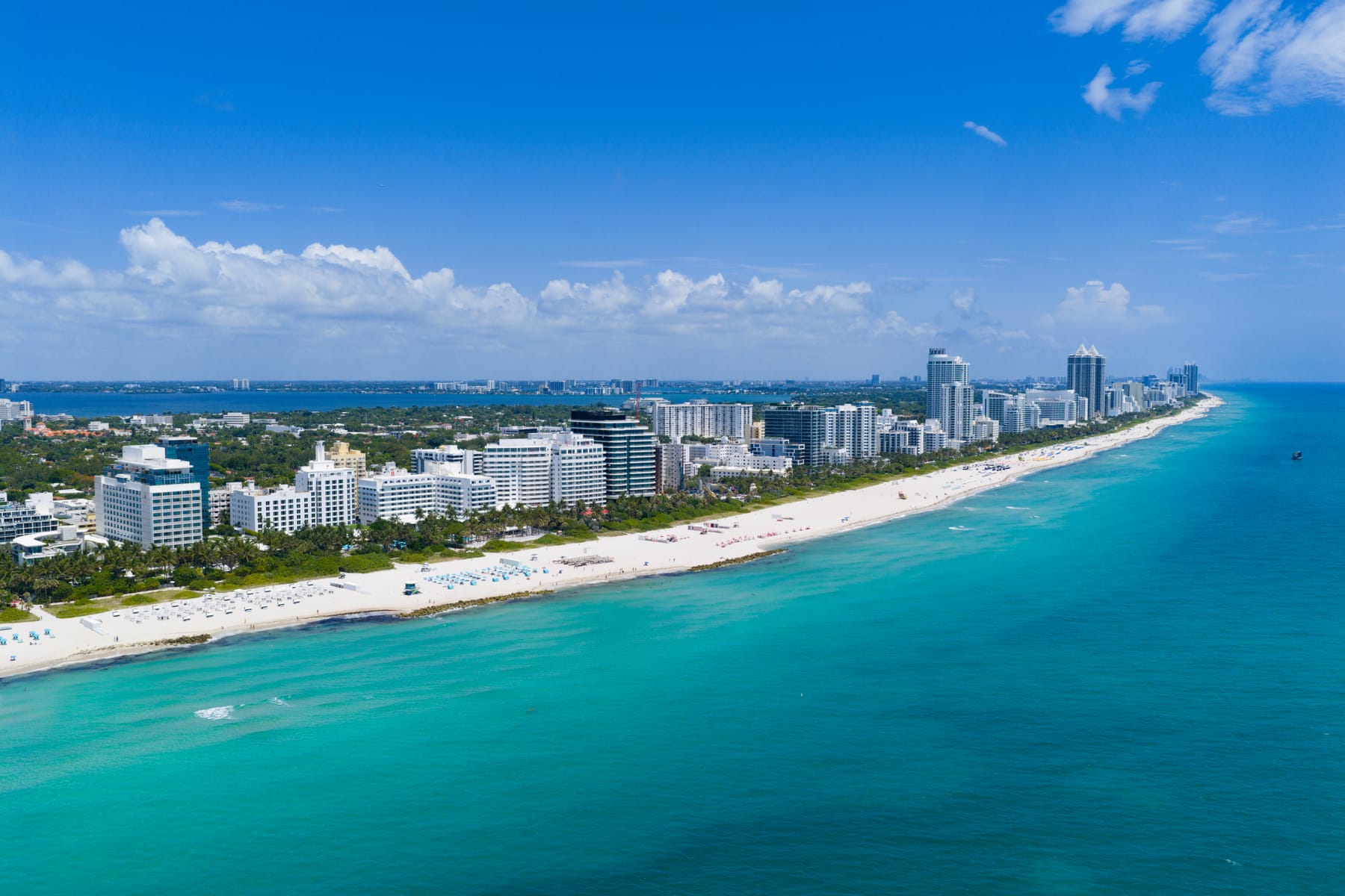 An aerial view of the Miami Beach coastline, its hotels and turquoise water