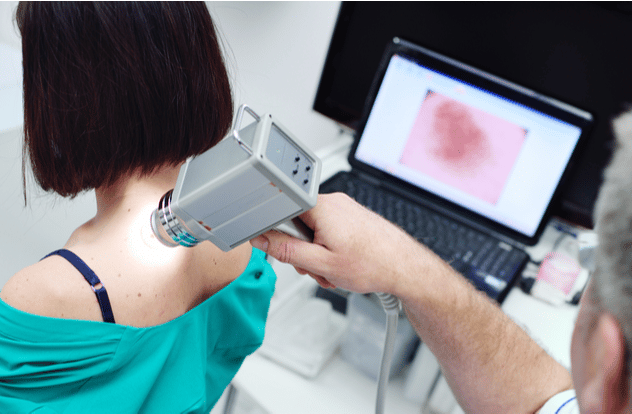 The doctor examines neoplasms or moles on the patient's skin